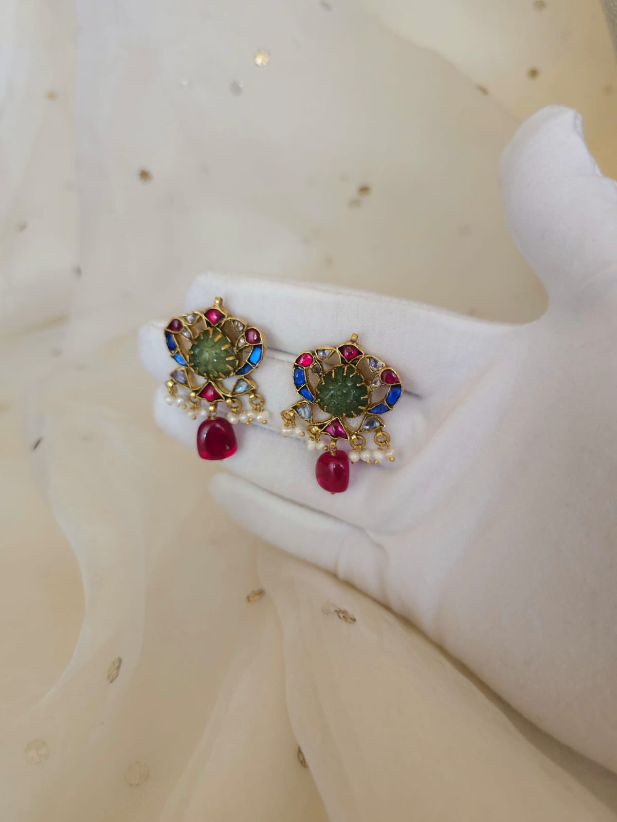 The sacred blue peacock spinel studs